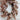 A autumn door wreath hanging on a white front door.