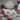 Red Christmas tea towels, gingham and wreath, hanging on an oven door
